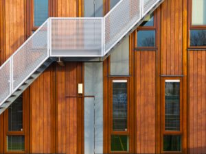 Metal stairs on a modern wooden facade